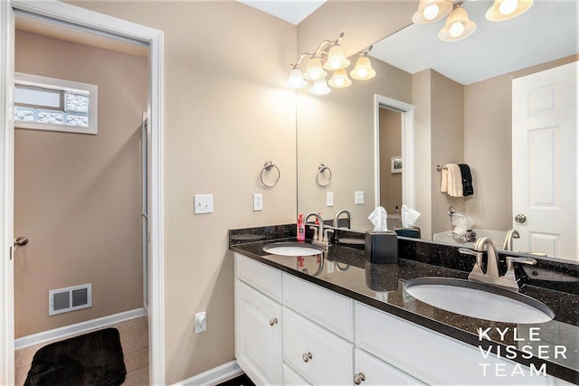 2139 Anderson Dr SE, Grand Rapids, MI 49506 - bathroom featuring tile patterned flooring, a sink, visible vents, and double vanity