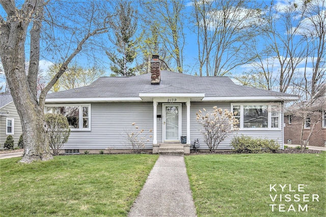2139 Anderson Dr SE, Grand Rapids, MI 49506 - bungalow-style home featuring a chimney, roof with shingles, and a front yard