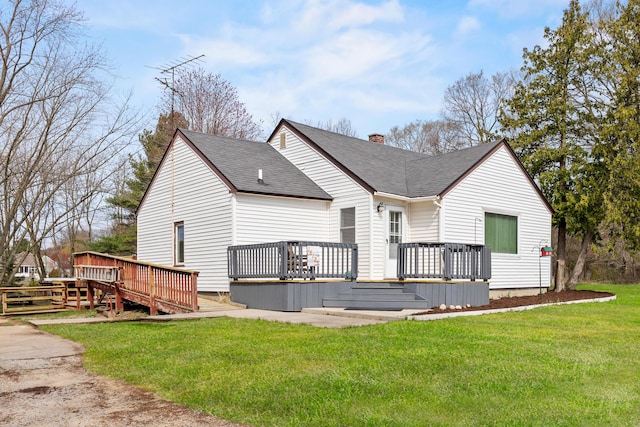 18125 174th Ave, Spring Lake, MI 49456 - rear view of house featuring a wooden deck, a yard, a shingled roof, and a chimney
