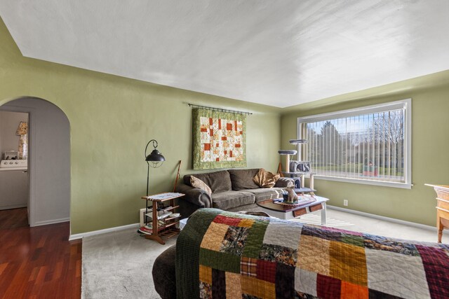 18125 174th Ave, Spring Lake, MI 49456 - living area featuring baseboards, arched walkways, and washer / dryer