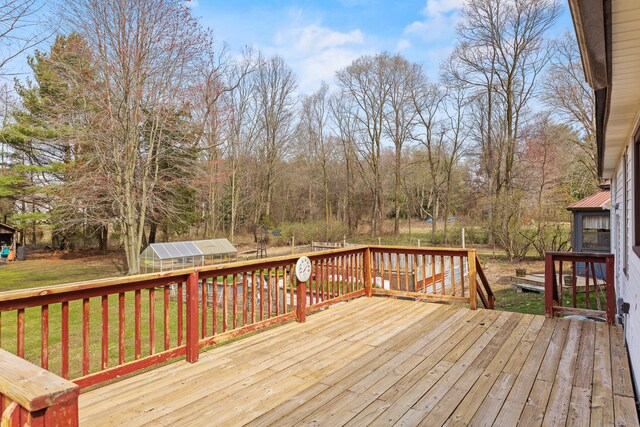 18125 174th Ave, Spring Lake, MI 49456 - wooden terrace featuring a lawn, an outbuilding, and an exterior structure