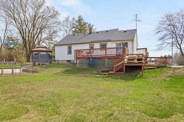 18125 174th Ave, Spring Lake, MI 49456 - back of house with a lawn, a chimney, roof with shingles, and a deck
