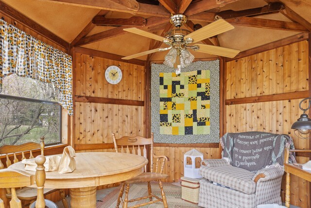 18125 174th Ave, Spring Lake, MI 49456 - dining space featuring lofted ceiling with beams, ceiling fan, and wooden walls