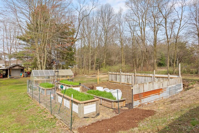 18125 174th Ave, Spring Lake, MI 49456 - view of yard with an outdoor structure, a garden, a greenhouse, and fence