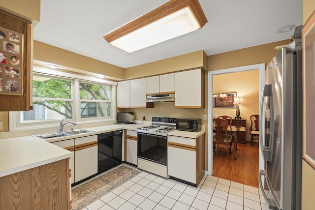 2448 Shoreham Highlands Dr, Saint Joseph, MI 49085 - kitchen with a sink, black appliances, under cabinet range hood, white cabinetry, and light countertops