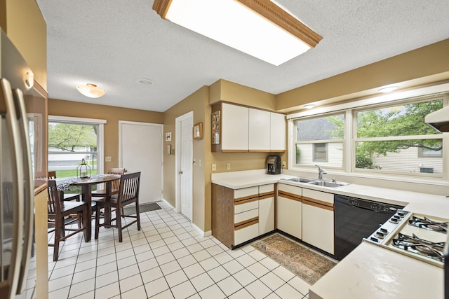 2448 Shoreham Highlands Dr, Saint Joseph, MI 49085 - kitchen with a sink, stainless steel refrigerator, a textured ceiling, and light countertops