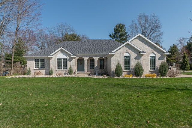 1060 Briarwood Ct, Norton Shores, MI 49441 - ranch-style home featuring a front lawn, brick siding, roof with shingles, and covered porch