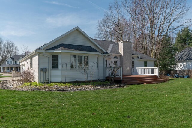 1060 Briarwood Ct, Norton Shores, MI 49441 - back of property with a wooden deck, a lawn, and a chimney