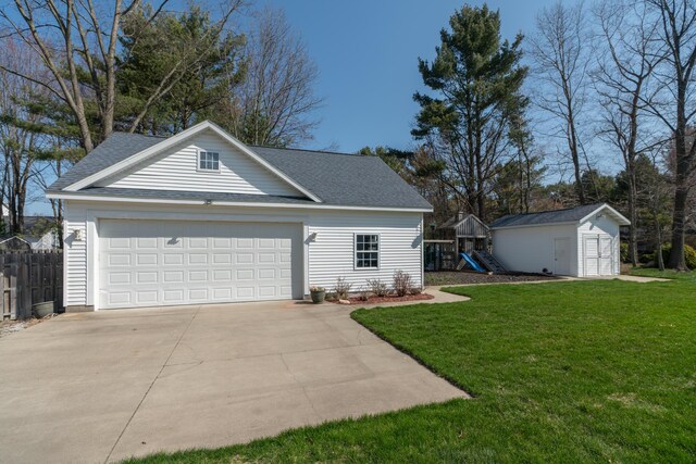 1060 Briarwood Ct, Norton Shores, MI 49441 - view of front of property featuring a front lawn, a playground, concrete driveway, fence, and an outdoor structure