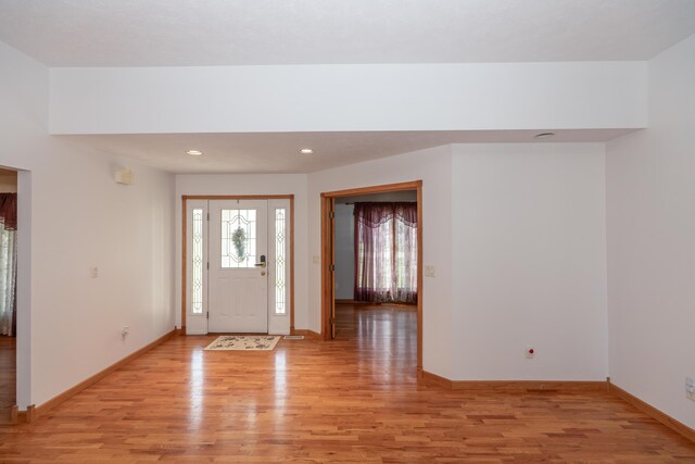 1060 Briarwood Ct, Norton Shores, MI 49441 - entryway featuring baseboards, light wood-style floors, and recessed lighting