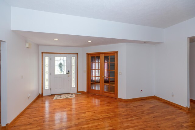 1060 Briarwood Ct, Norton Shores, MI 49441 - foyer entrance with light wood-style floors and baseboards