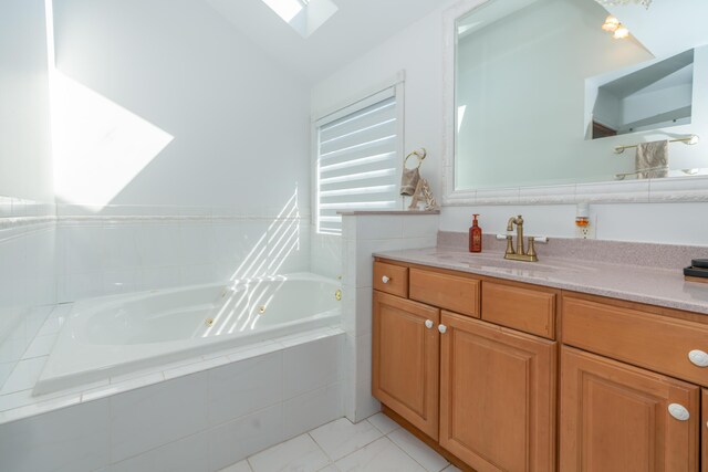1060 Briarwood Ct, Norton Shores, MI 49441 - bathroom featuring a jetted tub, vanity, and vaulted ceiling with skylight