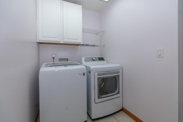 1060 Briarwood Ct, Norton Shores, MI 49441 - laundry area with washing machine and clothes dryer, baseboards, and cabinet space