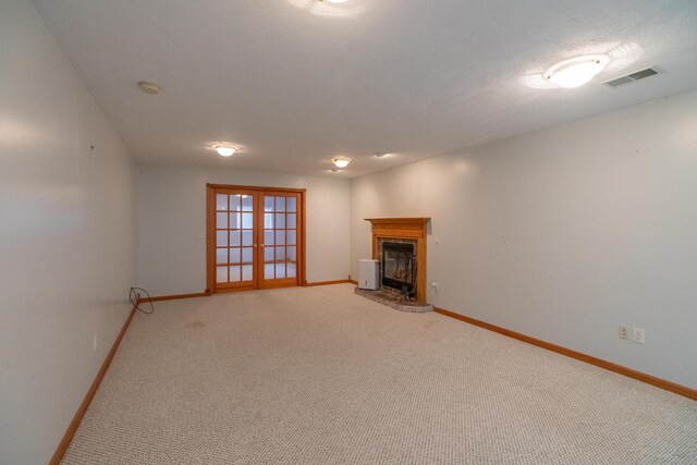 1060 Briarwood Ct, Norton Shores, MI 49441 - unfurnished living room featuring visible vents, baseboards, light carpet, and french doors