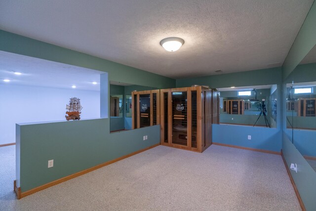 1060 Briarwood Ct, Norton Shores, MI 49441 - unfurnished room featuring baseboards, a textured ceiling, and carpet