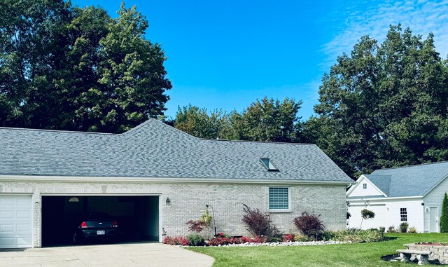 1060 Briarwood Ct, Norton Shores, MI 49441 - view of side of property featuring concrete driveway, brick siding, a yard, and a garage