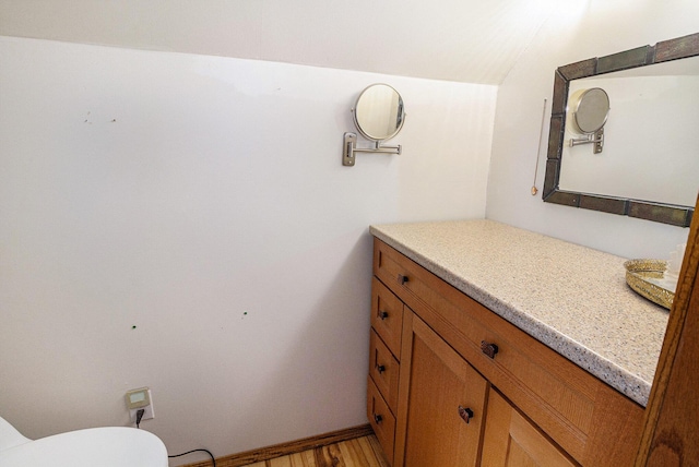 3175 Kalmbach Rd, Grass Lake, MI 49240 - half bath featuring vanity, toilet, and wood finished floors