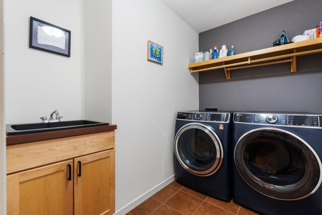4138 W Loch Alpine Dr, Ann Arbor, MI 48103 - washroom with cabinet space, washer and clothes dryer, dark tile patterned floors, and baseboards