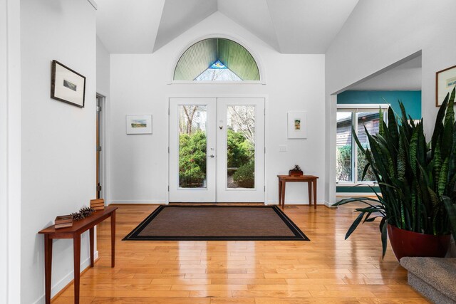 4138 W Loch Alpine Dr, Ann Arbor, MI 48103 - foyer entrance with wood finished floors, vaulted ceiling, and french doors