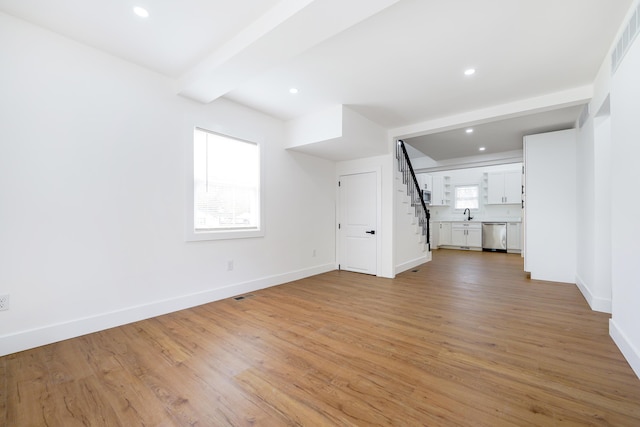 21611 Conners Ave, Warren, MI 48091 - unfurnished living room featuring baseboards, light wood-style flooring, stairs, and visible vents