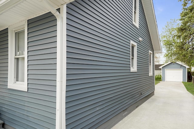 21611 Conners Ave, Warren, MI 48091 - view of side of home featuring an outbuilding, a detached garage, and concrete driveway