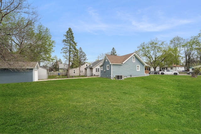 21611 Conners Ave, Warren, MI 48091 - exterior space featuring a yard, fence, an outbuilding, and central AC unit