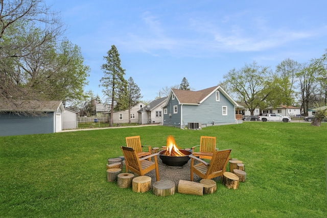21611 Conners Ave, Warren, MI 48091 - view of yard with a fire pit, central air condition unit, and an outbuilding