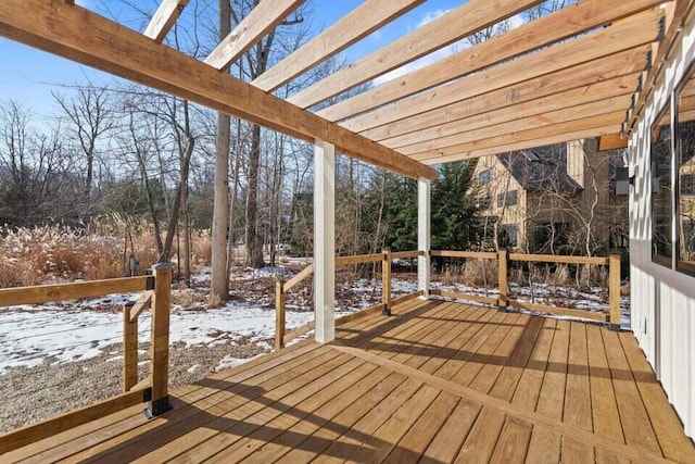 snow covered deck featuring a pergola