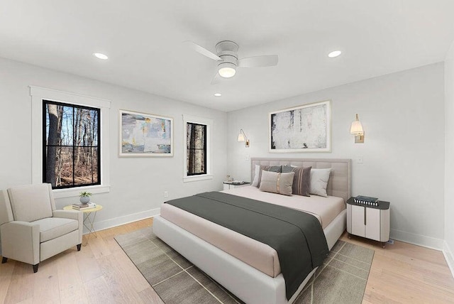bedroom with recessed lighting, light wood-style floors, and baseboards