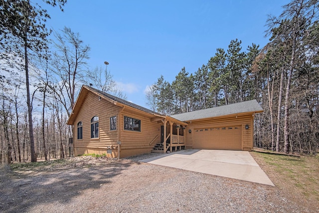 11365 Phal Rd, Grass Lake, MI 49240 - chalet / cabin featuring an attached garage and driveway