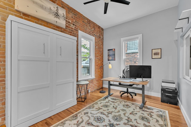113 S Fourth Ave Unit 6, Ann Arbor, MI 48104 - office space featuring brick wall, light wood-style floors, a ceiling fan, and baseboards