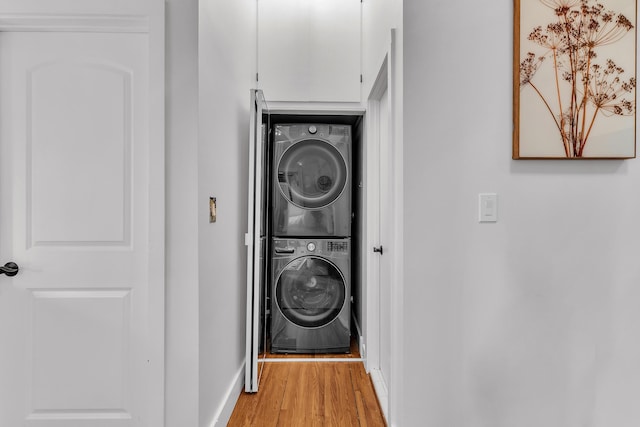 113 S Fourth Ave Unit 6, Ann Arbor, MI 48104 - washroom with stacked washer / drying machine, light wood-style floors, and baseboards