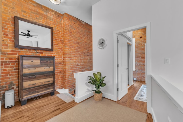 113 S Fourth Ave Unit 6, Ann Arbor, MI 48104 - hall with wood finished floors, brick wall, and baseboards