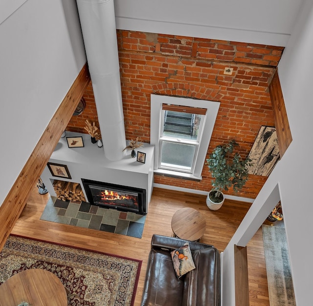 113 S Fourth Ave Unit 6, Ann Arbor, MI 48104 - living room with a glass covered fireplace, brick wall, and wood finished floors