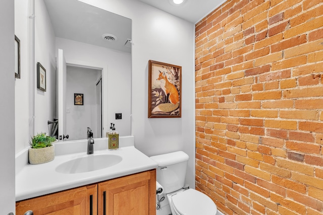 113 S Fourth Ave Unit 6, Ann Arbor, MI 48104 - half bath with brick wall, vanity, and toilet