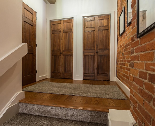 113 S Fourth Ave Unit 6, Ann Arbor, MI 48104 - foyer featuring brick wall and wood finished floors