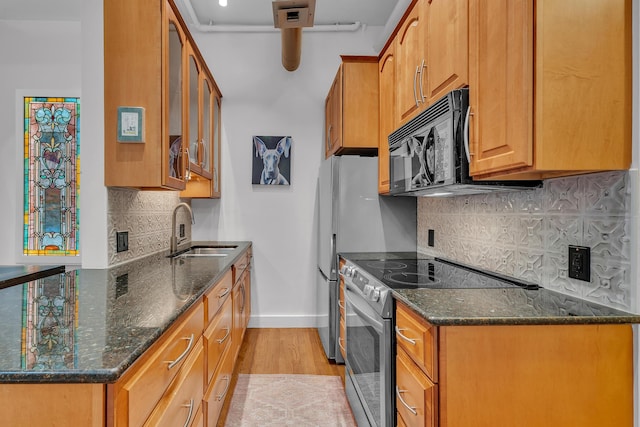 113 S Fourth Ave Unit 6, Ann Arbor, MI 48104 - kitchen with stainless steel electric range, baseboards, black microwave, a sink, and light wood-style flooring