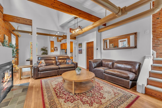 113 S Fourth Ave Unit 6, Ann Arbor, MI 48104 - living room with hardwood / wood-style floors, beam ceiling, a chandelier, and stairs