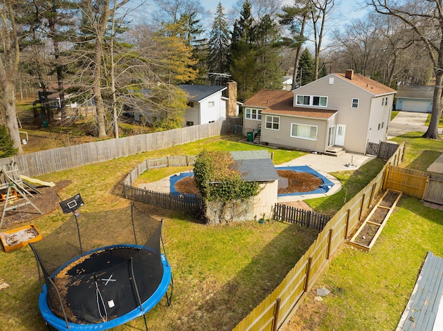 back of house with a storage shed, a trampoline, an outbuilding, a yard, and a patio