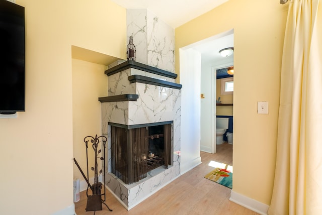 living area featuring a high end fireplace and wood finished floors