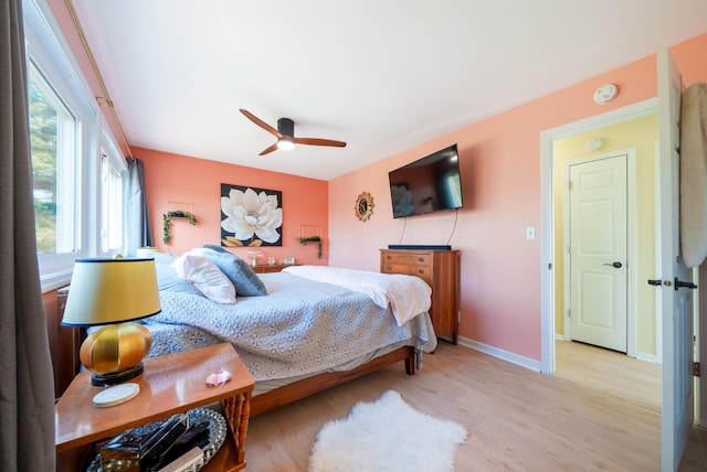 bedroom with baseboards, a ceiling fan, and wood finished floors