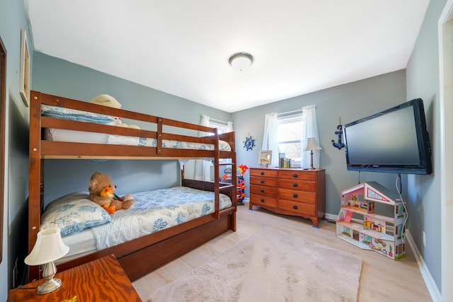 bedroom featuring baseboards and wood finished floors