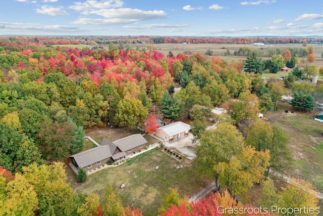 birds eye view of property featuring a wooded view