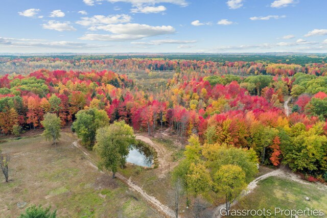 birds eye view of property featuring a view of trees