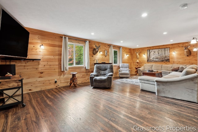 living room with recessed lighting, hardwood / wood-style floors, and wood walls