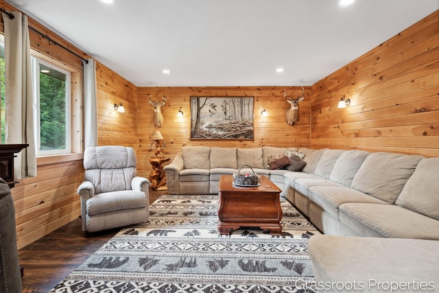 living room with wood walls, wood finished floors, and recessed lighting