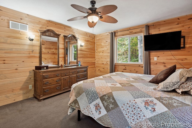 bedroom featuring carpet, visible vents, and wood walls