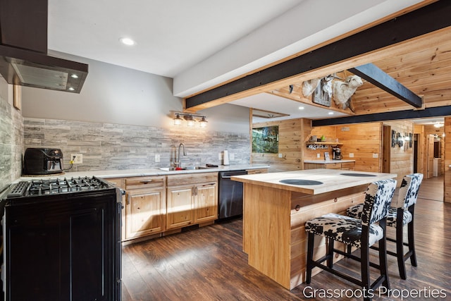 kitchen with a sink, beamed ceiling, wood walls, black range with gas cooktop, and dishwasher