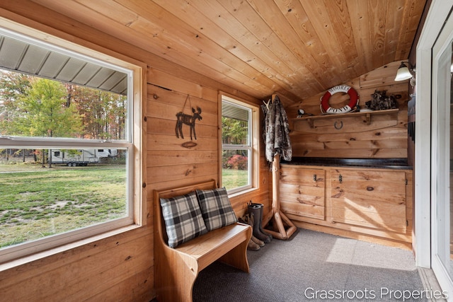 sitting room featuring wood ceiling, vaulted ceiling, wood walls, and carpet flooring