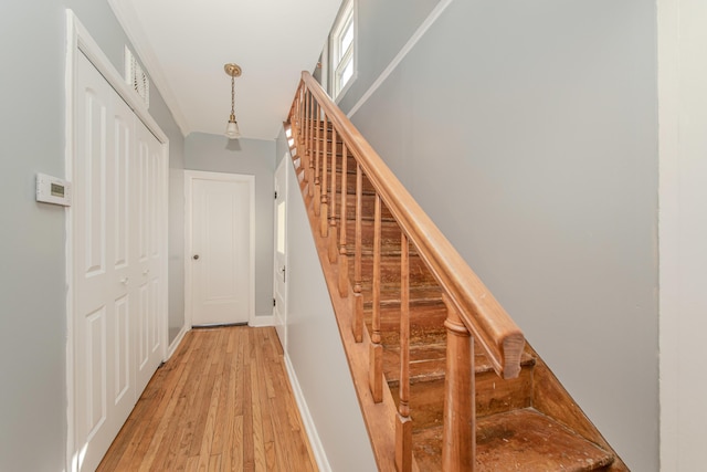 stairway featuring hardwood / wood-style flooring and baseboards